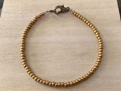 This dark gold bead bracelet features toho seed beads (size 8/0) in a striking, antique gold hue. I love the minimalist vibe to these layering pieces, and these beaded bracelets make great friendship gifts. Available in whole & half sizes, 6-9". Please ask if you have any questions. Please click below to visit my shop: https://etsy.com/shop/pepperandpomme Brass Beaded Bracelets With Round Beads, Gold Beaded Bracelets With Tiny Beads For Everyday, Everyday Tiny Beads Gold Bracelets, Everyday Gold Beaded Bracelets With Tiny Beads, Hand-strung Brass Bracelets With Round Beads, Handmade Minimalist Gold Beads, Adjustable Brass Beaded Bracelets With Gold Beads, Brass Bracelets With Round Gold Beads, Everyday Bohemian Gold Beads