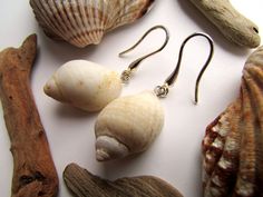 Hypoallergenic earrings with two natural, carefully selected seashells. The seashells are filled with clear high quality epoxy resin to make sure they won't break easily. These elegant earrings will add a light, playful detail to your outfit or make a priceless gift for any woman who appreciates the beauty of nature and the value of unique, handmade jewelry. Size: 47 mm (1.85 inches) If you like sea inspired home decorations and jewellery, have a look at my shop, where you'll find a wide range o Elegant Shell Earrings With Ear Wire, Ocean-inspired Shell With Matching Earrings, White Shell-shaped Pearl Earrings For Beach, White Shell Pearl Drop Earrings, Shell-shaped Pearl Earrings For Beach, White Shell Pearl Earrings For Beach, Elegant Hypoallergenic Earrings For Beach, White Pearl Earrings For The Beach, Nickel-free White Shell