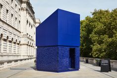 a large blue object sitting on top of a sidewalk