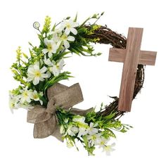 a wreath with white flowers and a cross