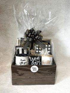 a gift box with coffee mugs and other items