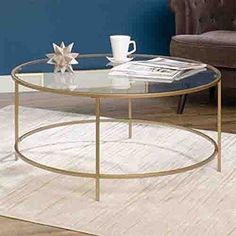 a glass coffee table sitting on top of a wooden floor next to a brown chair