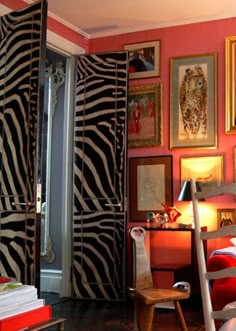 a room with zebra print walls and pictures on the wall