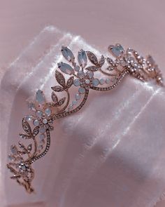 a tiara is sitting on a white cloth