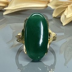 "Oval Green Jade Gemstone and Sterling Silver, Yellow or Rose Gold Filled Wire Wrapped Statement Ring; Custom Made to Size MATERIALS: ❀This large oval Green Jade gemstone wire wrapped ring is handmade with an approximately 20mm by 10mm semi precious gemstone bead and your choice of wire for the band. SIZING: ❀  This ring (as well as all the others in my shop) is custom made to any size from 4 to 14 including half and quarter sizes!  DIRECTIONS FOR CHECKOUT To checkout, please select the SIZE of Wire Wrapped Ring, Jade Gemstone, Wire Wrapped Rings, Argentium Silver, Green Jade, Wrap Rings, Jade Green, Silver Rose Gold, Sterling Ring