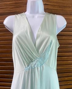 Vanity Fair seafoam/mint green long nightgown. Top is more of a mint color and bottom is more of a seafoam with blue tone. Lace detail at waist and draped bust area. Free flowing hips. Marked a size 32 which is a modern small. In very good vintage condition. Made in the USA. 100% nylon.  Measures 54" in length x 15" across chest Green Summer Sleepwear For Wedding Night, Green Summer Wedding Night Sleepwear, Green Sleeveless Nightgown For Loungewear, Green Spring Nightgown For Sleep, Green Lace Trim Nightgown For Loungewear, Vintage Light Blue Nightgown For Spring, Green V-neck Nightgown For Spring, Green V-neck Nightgown For Sleep, Green V-neck Nightgown For Bedtime