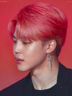 a close up of a person with red hair and piercings on their ears, looking to the side