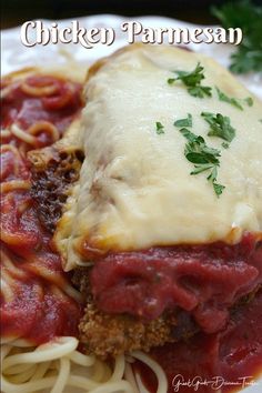 chicken parmesan with sauce and noodles on a plate