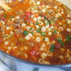 a pot filled with pasta and meat soup