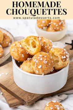 homemade chocolate donuts with sprinkles in a white bowl on a wooden cutting board