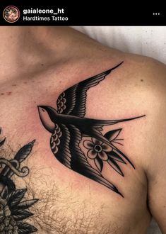 a man's chest with a bird tattoo on it