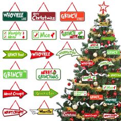 a christmas tree with many different signs hanging from it's sides and an arrow pointing to the right