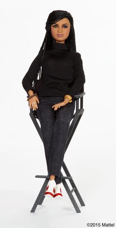 a doll sitting on top of a chair with her hands in her pockets and legs crossed