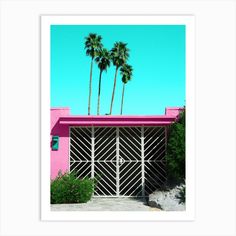 a pink house with two palm trees in the background