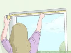 a woman measuring the length of a window with a tape measure on it's side