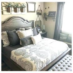 a large bed sitting next to a window covered in pillows and throw pillow covers on top of it