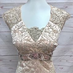 a dress on a mannequin with an intricate design and beaded details,