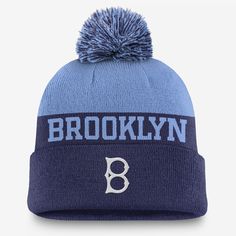 A cold-weather staple, this Rewind Peak Beanie helps keep you warm and comfortable with a classic cuffed design and soft, stretchy acrylic yarns. Its throwback Brooklyn Dodgers details are paired with a pom and solid-color look for versatility. Nike Winter Beanie Hat, Brooklyn Dodgers Hat, Dodger Hats, Brooklyn Dodgers, Sneaker Dress Shoes, Maternity Shops, Women Men Shoes, Pom Beanie, Knit Hat