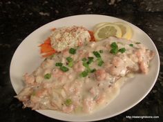 a white plate topped with meat covered in gravy