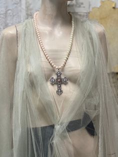 Large Baroque cross pendant necklace. I have used glass pearls for the chain and have the pearls are ombré they start off as ivory merge into a light peach colour. This unique colour matches beautifully the light peach Swarovski crystal I gave used at the center of the cross. Also in the colour light peach as named by Swarovski Glass Pearls are 10 mm in diameter. Cross is zinc alloy. I make the pearl chain in different length to suit you. Please choose your chain length from the drop down menu Elegant Pearl Necklace With Cross Pendant, Elegant Cross Pendant Necklace With Pearl Drop, Elegant Cross Necklace With Pearl Drop, Elegant Pearl Cross Necklace With Pearl Drop, Elegant Pearl Drop Cross Pendant Necklace, Elegant Cross-shaped Pearl Necklace For Wedding, Elegant Beaded Cross Pendant Necklace, Elegant Cross-shaped Pearl Chain Necklace, Elegant Cross-shaped Pearl Pendant Necklace