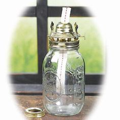 a glass jar filled with money sitting on top of a table next to a window