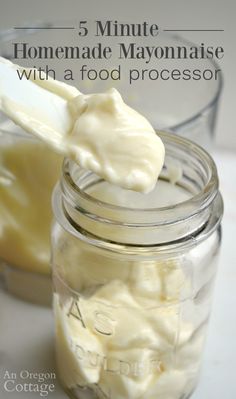 a jar filled with white mayonnaise next to a spoon