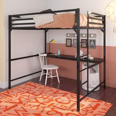 a bunk bed with desk underneath it in a room that has pink walls and hardwood floors