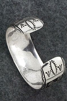 This expertly crafted sterling silver bracelet featuring horses was made by Navajo silversmith Richard Singer. The back is signed R Singer and stamped .925.Size: 5 5/8" (will fit up to a 6 3/4" wrist)Gap: 1 1/8"Width: 1"Free shipping on all orders! We ship with USPS and always include tracking. All orders ship within a day of payment.Returns are accepted up to 30 days after you receive your order. Just send us a message. Our shop offers cash back or store credit. The item must be returned in new Southwestern Silver Cuff Bracelet With Inlay, Adjustable Etched Southwestern Sterling Silver Bracelet, Adjustable Etched Sterling Silver Southwestern Bracelet, Sterling Silver Southwestern Bracelet With Polished Finish, Hand Tooled Western Silver Jewelry, Silver Engraved Western Cuff Bracelet, Engraved Silver Western Cuff Bracelet, Southwestern Etched Bracelets For Collectors, Southwestern Sterling Silver Polished Bangle Bracelet