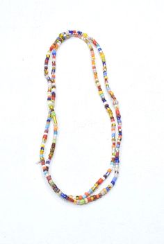 "This is a Wonderful Vintage African Bright Christmas Glass Bead Strand. Also called Christmas beads these multicolored 3-4mm glass beads are actually vintage Czech glass made to be sent to Africa. Christmas beads comprise of a special blend of choice beads created in former Czechoslovakia for use in Africa. Also known as \"African love beads,\" each strand is unique; no two strands are alike. A wonderful necklace to wear or cut up and use in all your creative jewelry designs. If wearing as a ne Vintage Multicolor Spacer Beads, Multicolor Handmade Glass Beads, Multicolor Polished Czech Glass Beaded Necklaces, Multicolor Polished Czech Glass Beaded Necklace, Multicolor Glass Beaded Necklaces With Faceted Beads, Multicolor Faceted Glass Beaded Necklaces, Vintage Multicolor Beads For The Beach, Multicolor Glass Spacer Beads, Multicolor Faceted Czech Glass Beads