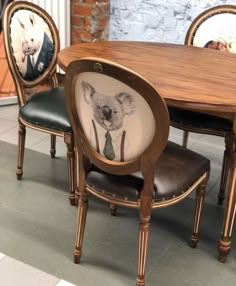 a wooden table topped with two chairs and a koala cushion on top of it