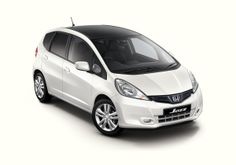 a white honda jazz parked in front of a white background