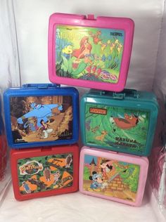 four children's lunchboxs with disney characters painted on the front and sides