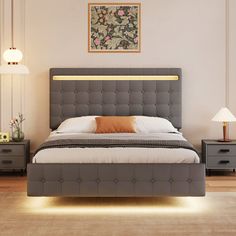 a bedroom with a bed, nightstands and two lamps on either side of the bed