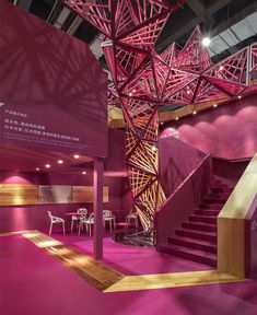 the interior of a building with pink walls and stairs