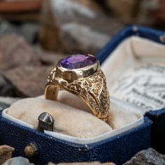 This vintage amethyst ring features scrolling work with latin phrases. The inside of the ring is inscibed "GLJ 64". The ring is currently a size 5.5 and we offer free resizing. The amethyst has a small chip partially hidden by the bezel. Vintage Amethyst Ring, Oval Amethyst Ring, Hunter College, Amethyst Ring Vintage, Latin Phrases, Brand Presentation, Old Boxes, Amethyst Jewelry, February Birth Stone