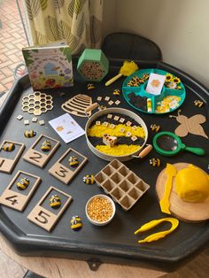 the table is full of wooden toys and crafts