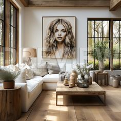 a living room with wooden floors and large windows, white couches and coffee table