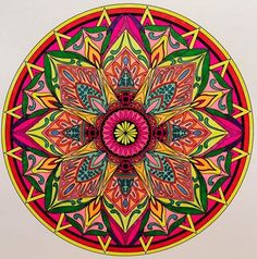 a drawing of a colorful flower in the middle of a circular design on white paper