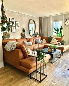 a living room filled with lots of furniture next to a wall mounted clock on the wall