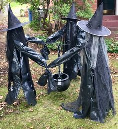 two witches are standing in the grass