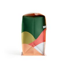 an orange and green paper bag on a white background with the bottom half folded up