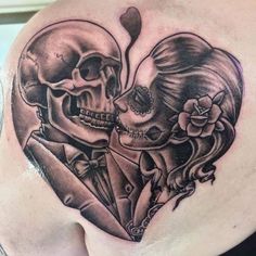 a woman with a skull tattoo on her shoulder and another skeleton behind her back, both in black and white