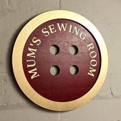 a red and gold sign that says sewing room