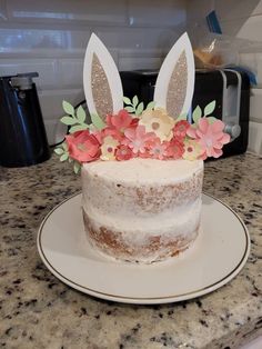 a cake decorated with flowers and bunny ears