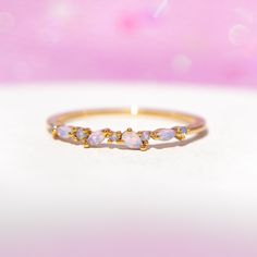 The Lily Ring is made with love! Each stone is embedded by hand, making each piece one of a kind. Wear it alone or pair it with your other rings to create the perfect #GCstack 18k gold plated, 18k rose gold plated, or rhodium plated over brass with a protective coating Pink cubic zirconia stones .8mm band width, Four marquise stones 3-3.5mm, Five round stones 1-1.5mm Available in sizes 5-8 Shop our entire Rings Collection here Lily Ring, Blue Lily, Rings Collection, Hand Making, Necklace Chain Lengths, Pink Ring, Brass Pendant, Wrap Rings, Jewelry Cleaner