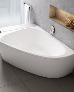 a white bath tub sitting on top of a tiled floor