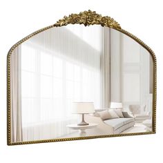 a mirror that is sitting on top of a table next to a couch and lamp