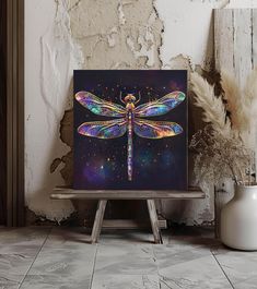 a painting of a dragonfly on a table