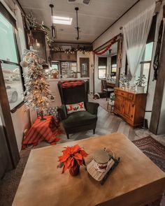 a living room filled with furniture and a christmas tree