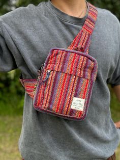 - Elevate your style with our handcrafted Pure Hemp Rasta Crossbody Bag - Versatile design doubles as a chest or waist belt for both men and women - Crafted from pure hemp, handwoven by skilled artisans in Nepal's mountain region - Vibrant Rasta colors add a bold and expressive flair to your ensemble - Features a small zip pocket in the front and a spacious main zip pocket - Keeps your essentials secure while on the go - Embrace conscious consumerism and support local communities and the environ Multicolor Rectangular Belt Bag For Everyday Use, Multicolor Rectangular Belt Bag With Removable Pouch, Multicolor Rectangular Belt Bag, Multicolor Belt Bag For Daily Use, Multicolor Crossbody Belt Bag For Daily Use, Multicolor Belt Bag With Pockets For Everyday Use, Multicolor Rectangular Belt Bag With Cell Phone Pocket, Multicolor Crossbody Chest Bag For Daily Use, Multicolor Crossbody Chest Bag For Everyday Use